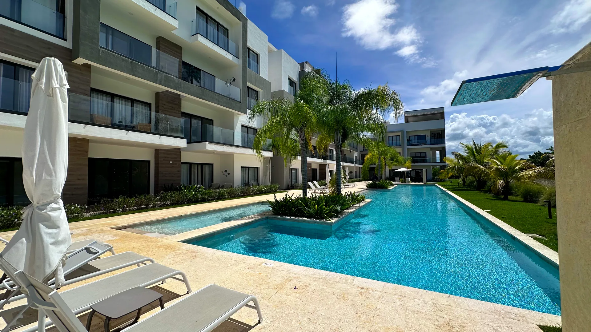 Cana Cove · Garden Residence A-101 — Sun loungers along the 220 m² residential pool