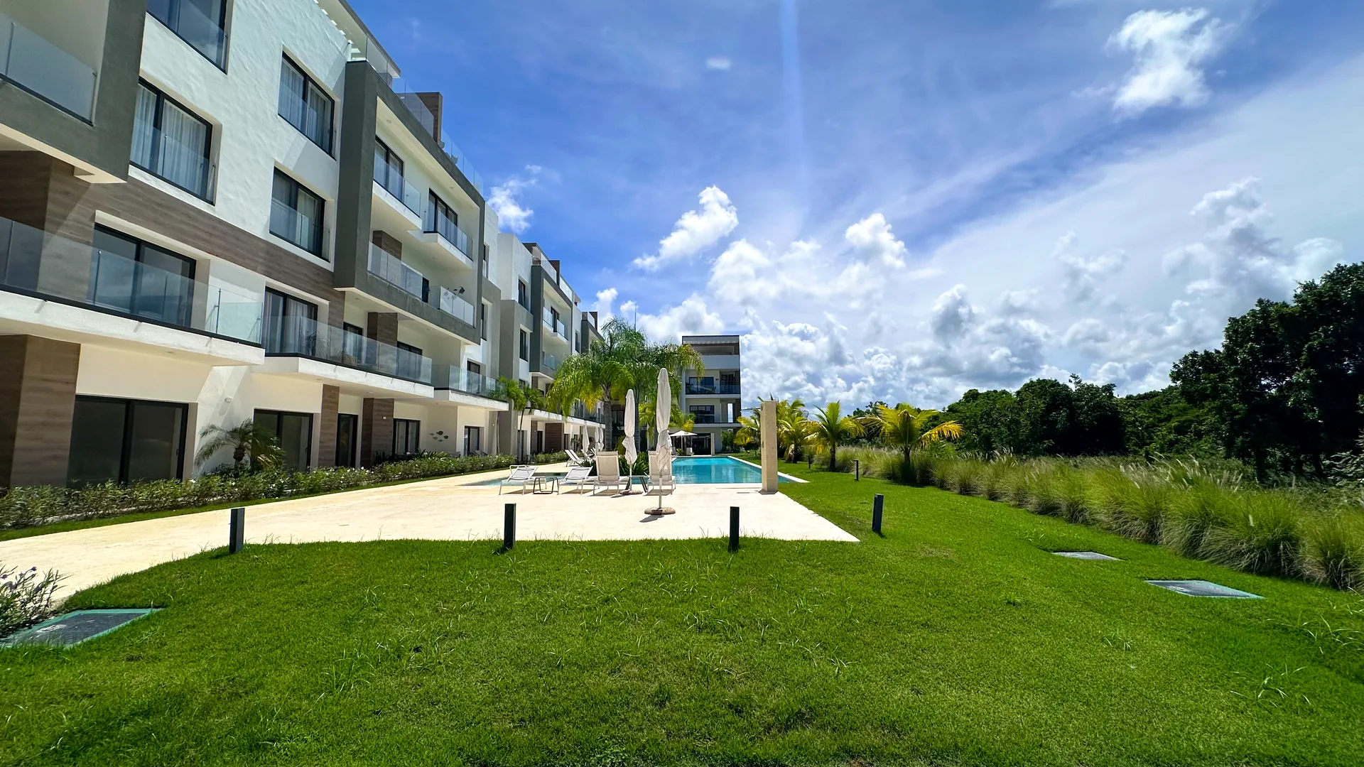 Cana Cove · Garden Residence A-101 — U-shaped buildings around the lawn and pool