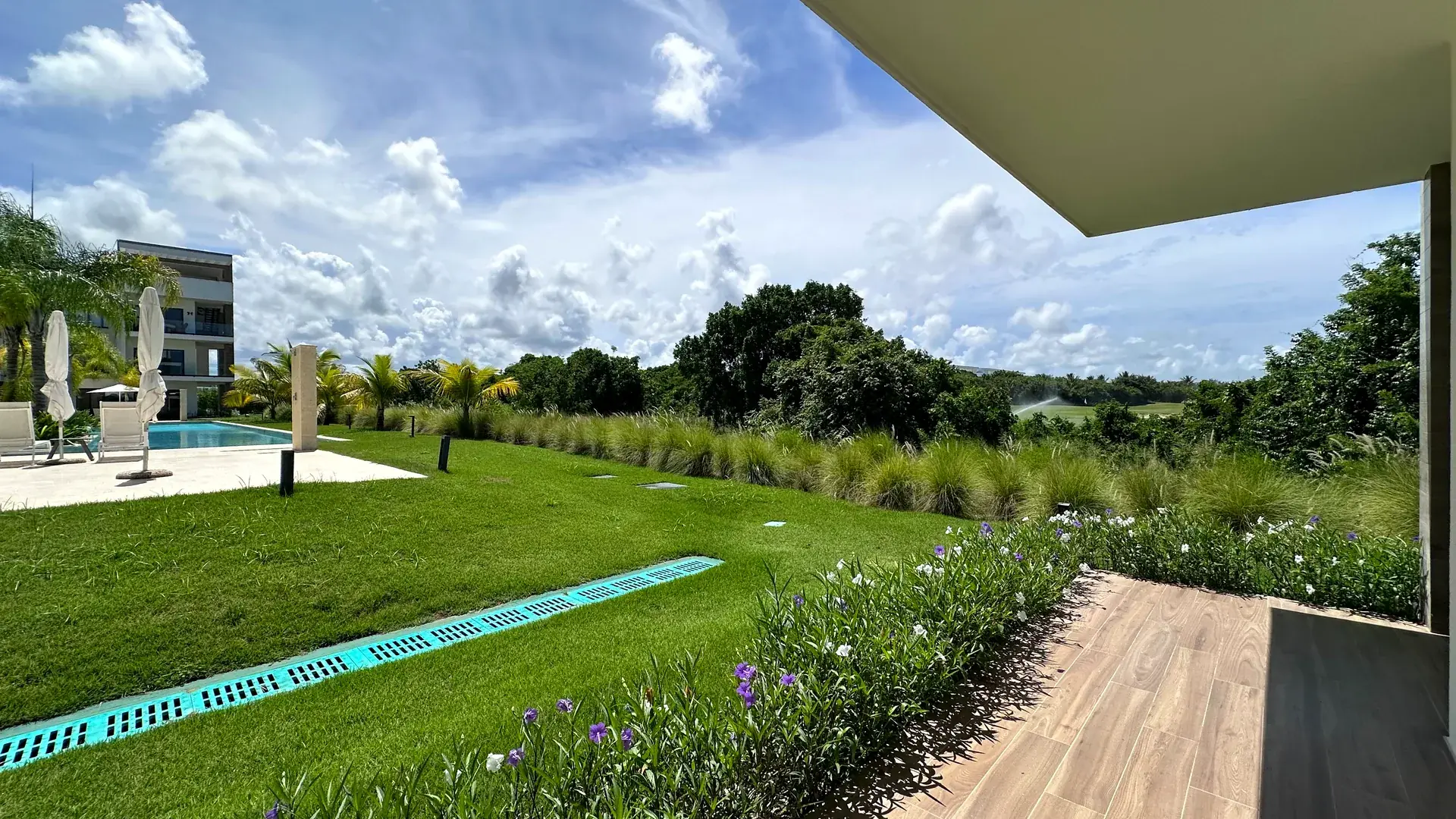 Cana Cove · Garden Residence A-101 — Private ground-floor terrace opening onto the garden