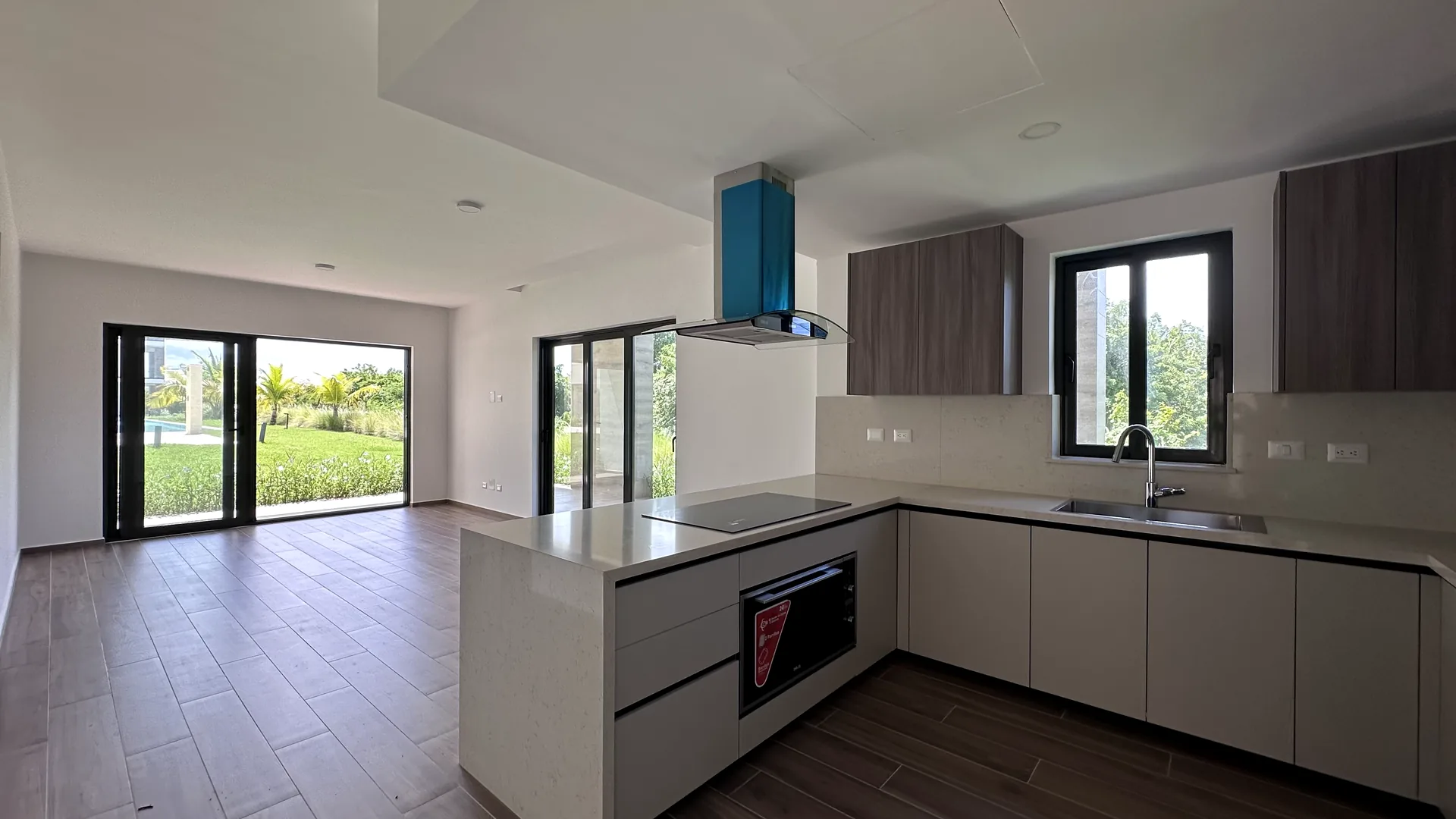Cana Cove · Garden Residence A-101 — Open kitchen and living area with garden light