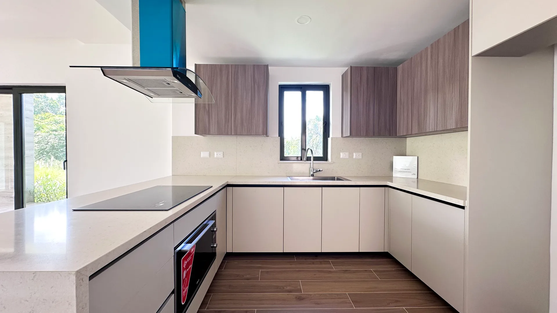 Cana Cove · Garden Residence A-101 — Fitted kitchen with glass-ceramic hob and oven
