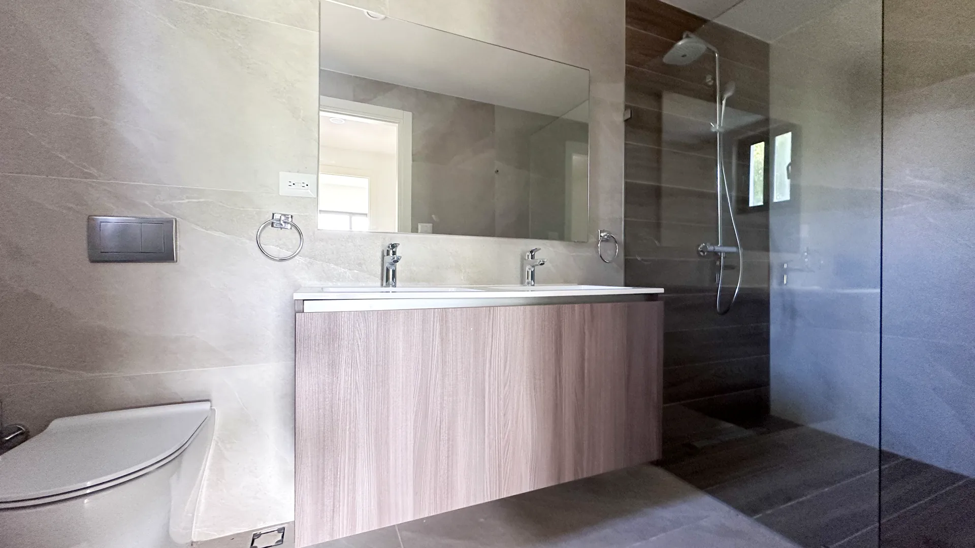 Cana Cove · Garden Residence A-101 — Bathroom with double vanity and walk-in shower