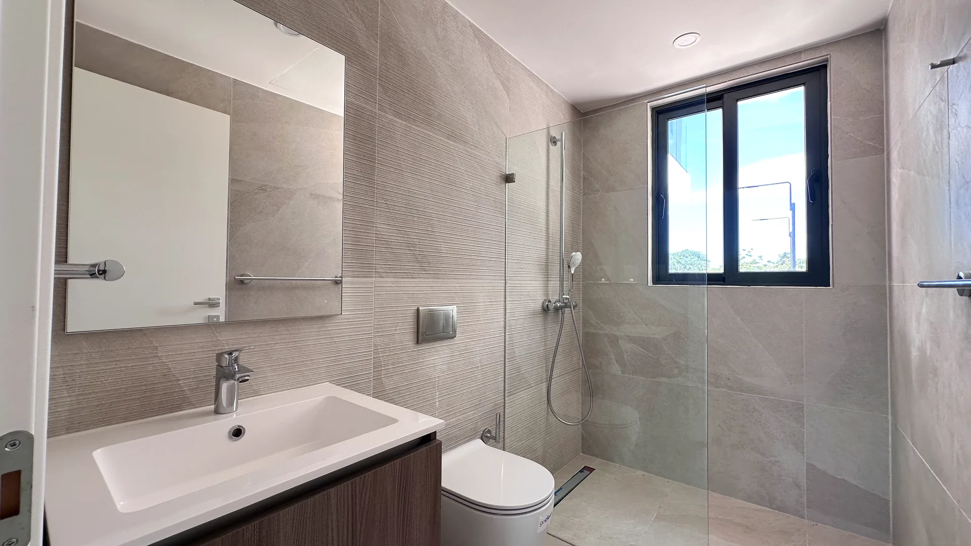Cana Cove · Garden Residence A-101 — Second bathroom with glass shower