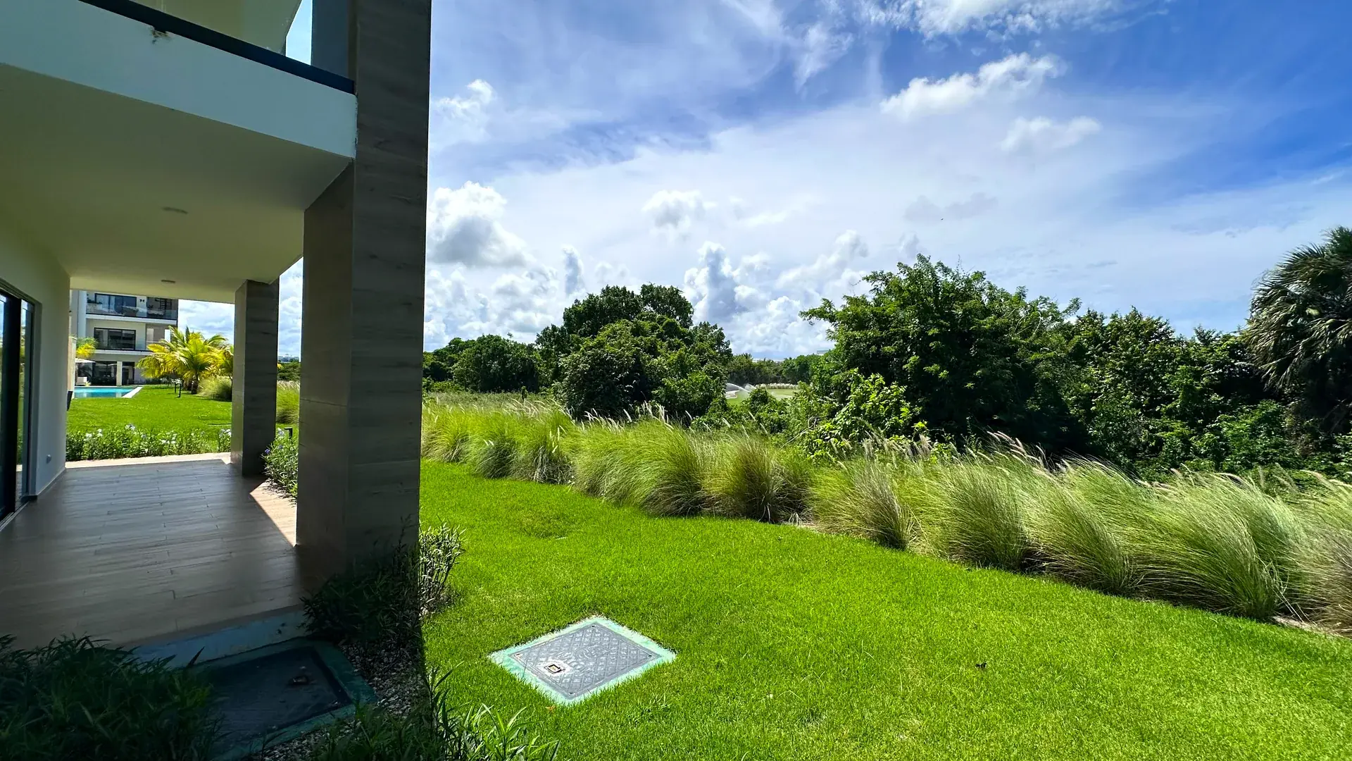 Cana Cove · Garden Residence A-101 — Garden and tropical greenery from the terrace