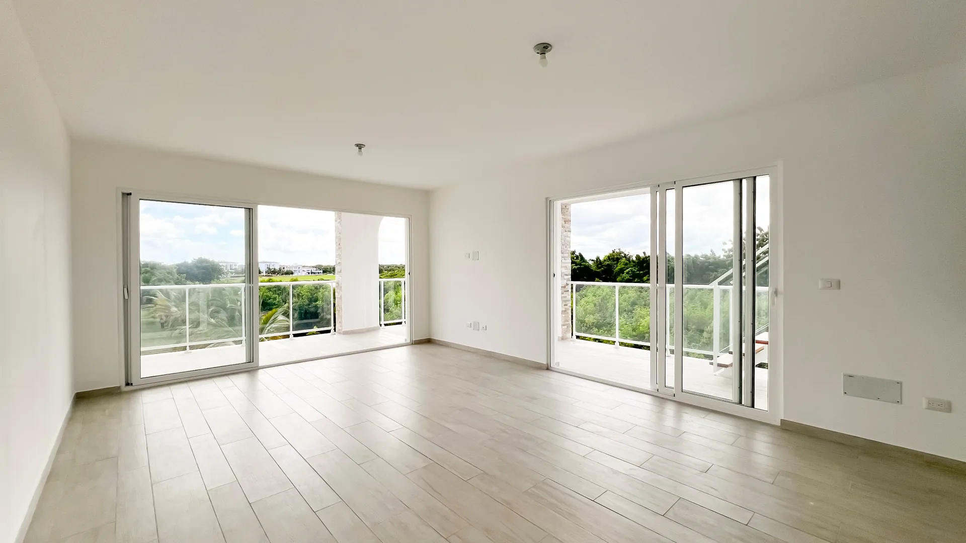 Cana Pearl · Rooftop Residence N-302 — Living area with floor-to-ceiling sliding doors