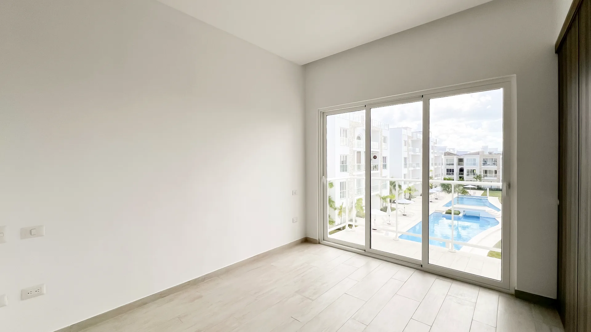 Cana Pearl · Rooftop Residence N-302 — Master bedroom with pool-view sliding doors