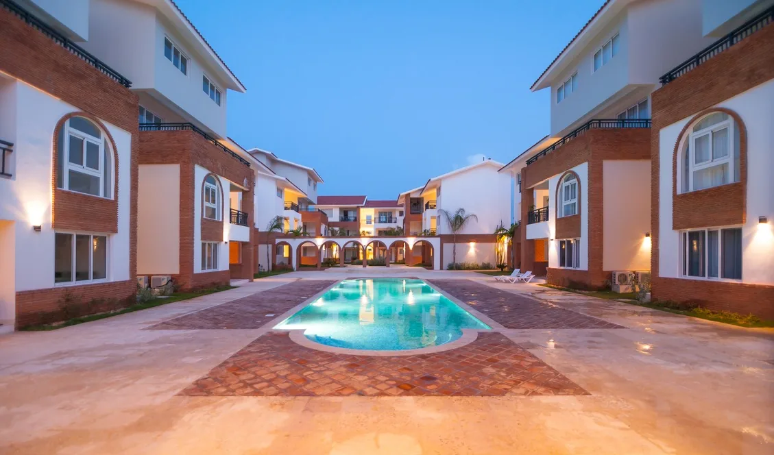 Coral Village · Apartment B-3-B — Central pool at dusk