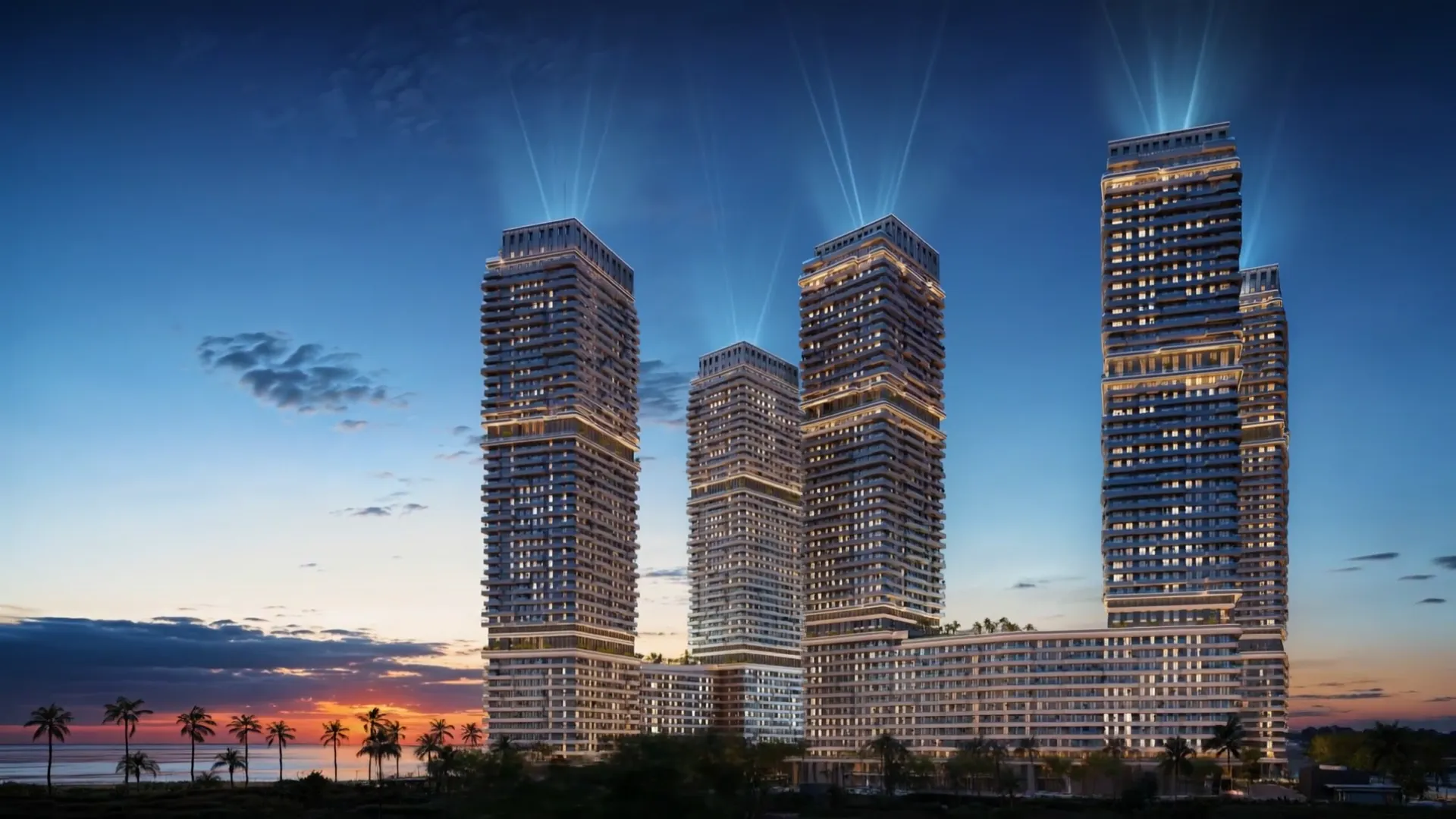 Coralia by Noval — The Coralia towers lit up at dusk on the Caribbean waterfront